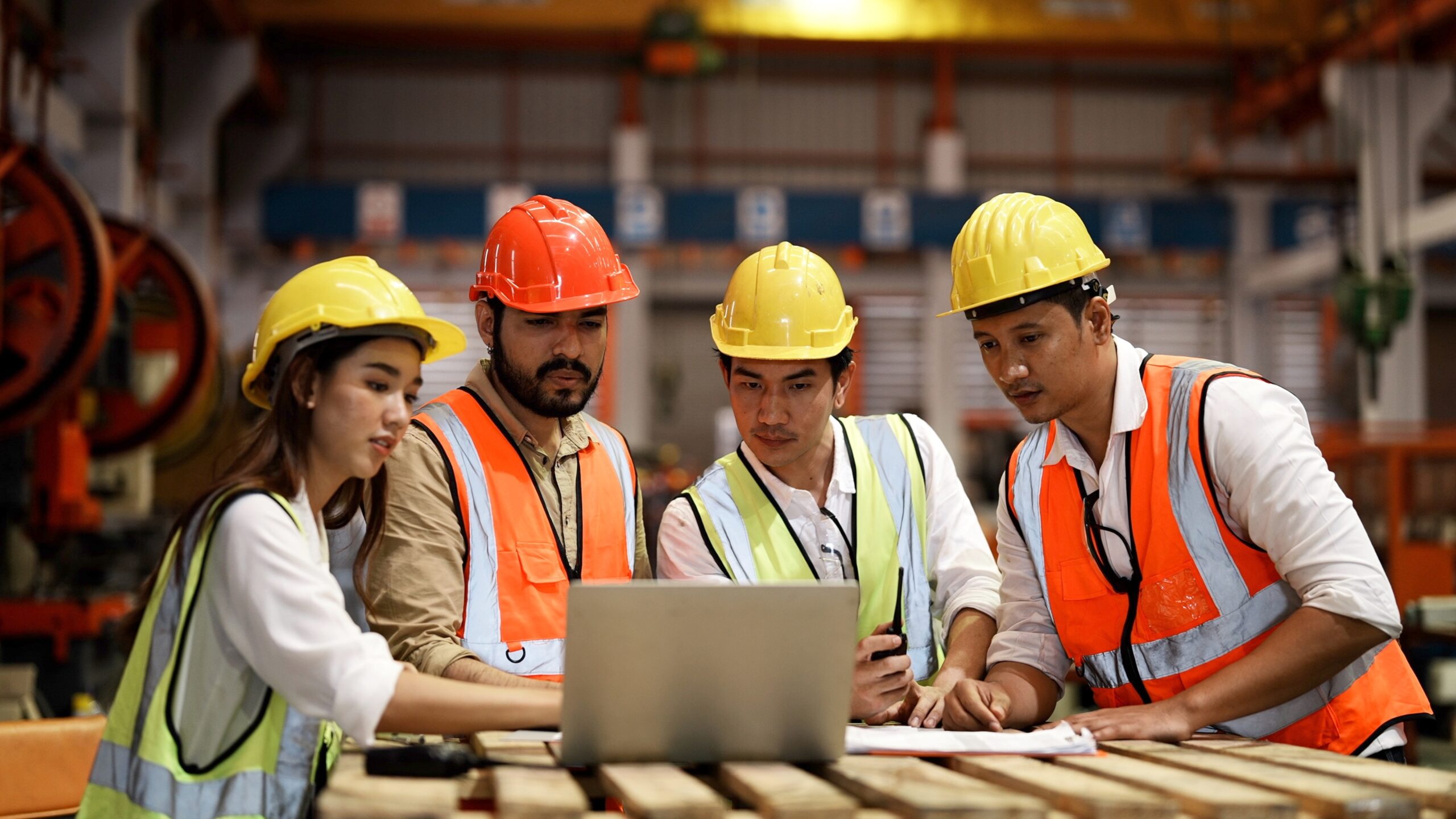 Multicultural industrial engineers manufacturer staff looking at