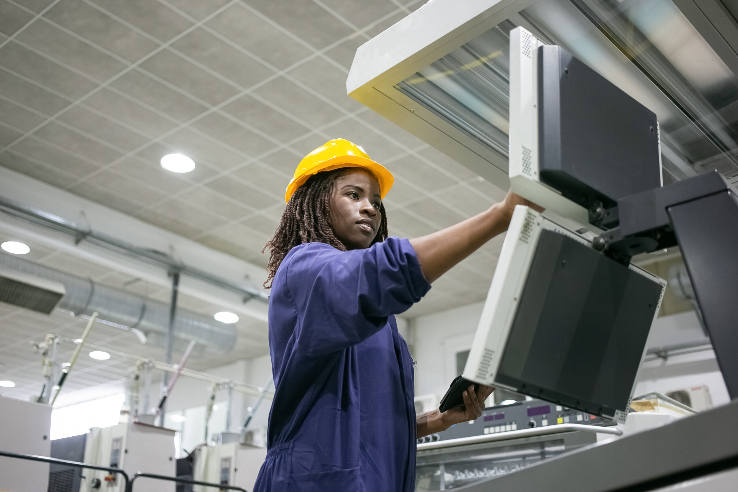 Focused confident black female factory worker